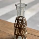Botellón de vidrio con fibra natural